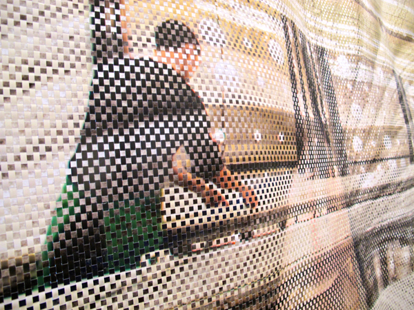 The composite image combines a wide shot of the factory cutting floor with a close-up of workers hands bunching textiles together.