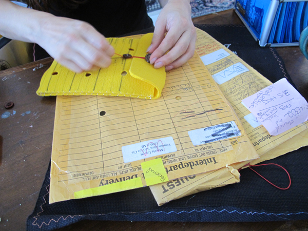 Wood pays homage to her conventional history, with felted versions of the all-to-familiar inter-office mailing envelope.