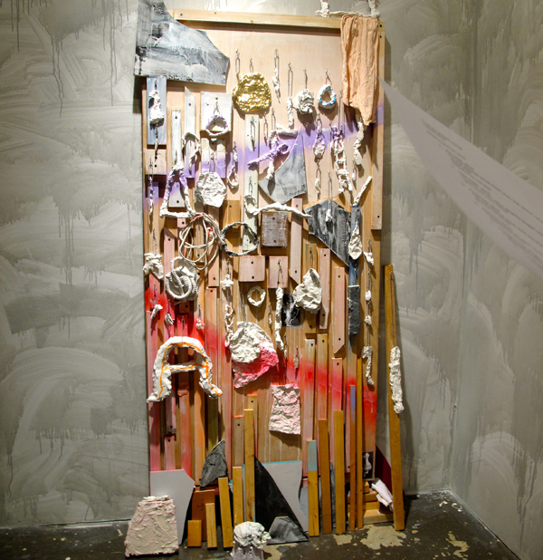 Fertility Goddess’ Survival Kit, 2013 - Cut and painted wood, found objects, aluminum foil, foam, plaster, spray paint, dyed lace, gouache, hooks, ball chain, painter’s rag, latex paint on wall.