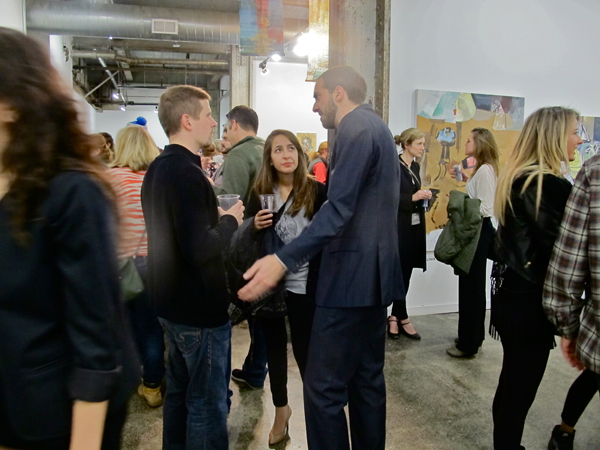 Artist Mike Burdick (center left), in conversation with some opening night patrons.