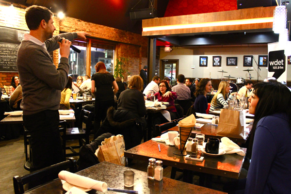 Delisi's co-host (standing left), about to pounce on an unsuspecting audience member for an opinion.