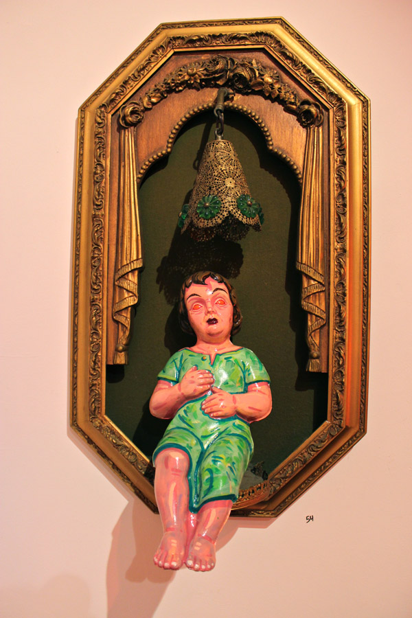 Painted statuary punctuates the exhibit; all of the materials are found objects salvaged from around Detroit.