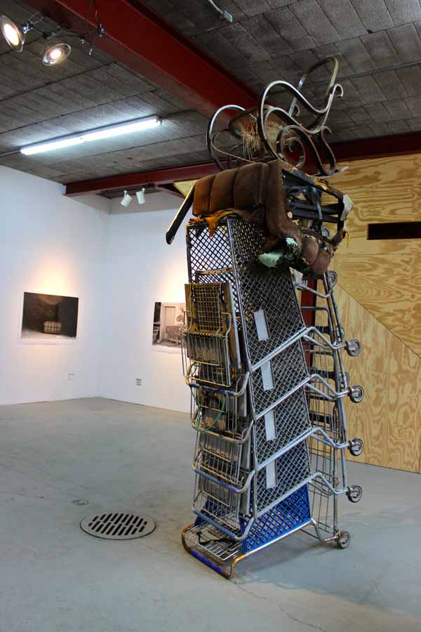 "SCRAP-A-HOUSE TOTEM," which may or may not be guarded by the protector spirit captured in the photograph. 