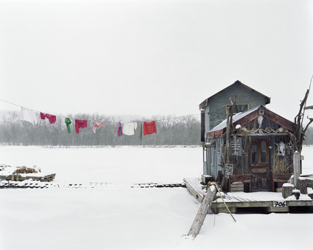 Alec Soth, "Peter&squot;s Houseboat. Winona, Minnesota. 2002" from the Sleeping by the Mississippi series. Courtesy of the artist&squot;s website.