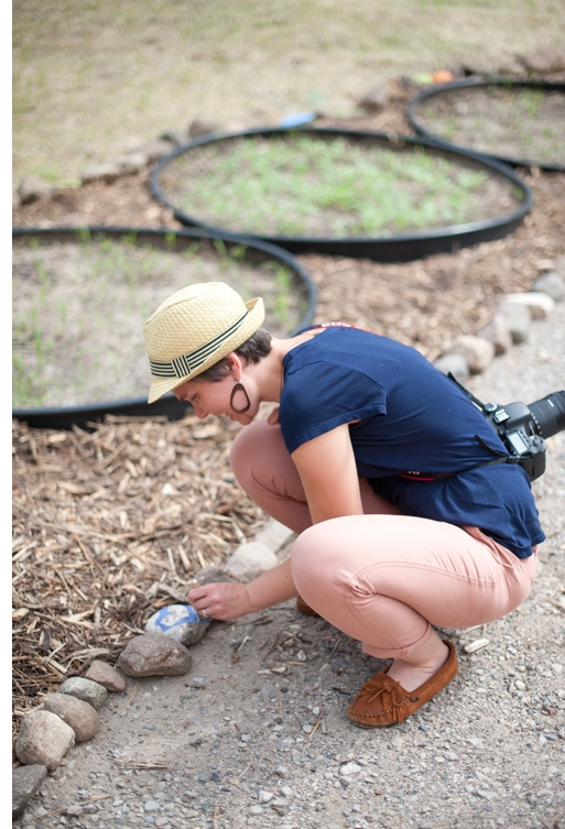 St. Paul City Artist in Residence, Amanda Lovelee, painting field stones at the new community garden space. Photo: Tiffany Bolk