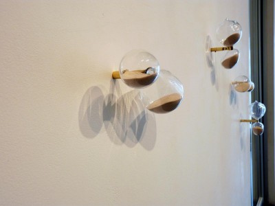 Wall works of hour glasses filled with industrial sand from Brazil.