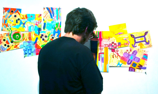Thompson painstakingly hangs delicate works by