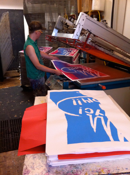 Just Seeds contributor, hard at work on the four-piece poster. Photo courtesy of justseeds.org.