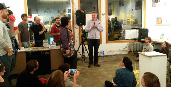 Barlow (center) introduces Rocheteau (standing left), demanding they sing a duet.