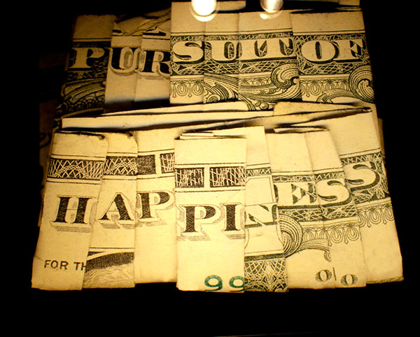 A piece from Live Free or Die, giant images of folded dollar bills, by Dan Tague, at KCAD.