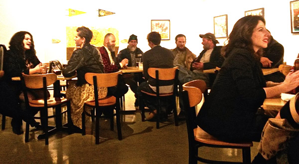 A lively opening night crowd, including the Cass Cafe's gallery curator, Dave Roberts (third from left).