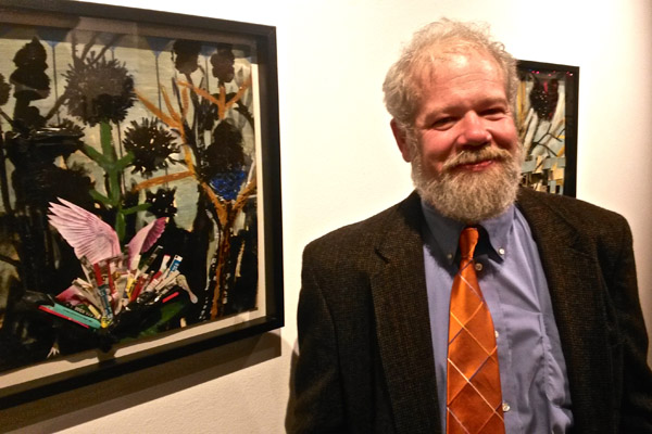 Hanna, alongside one of his collage/mixed media works.
