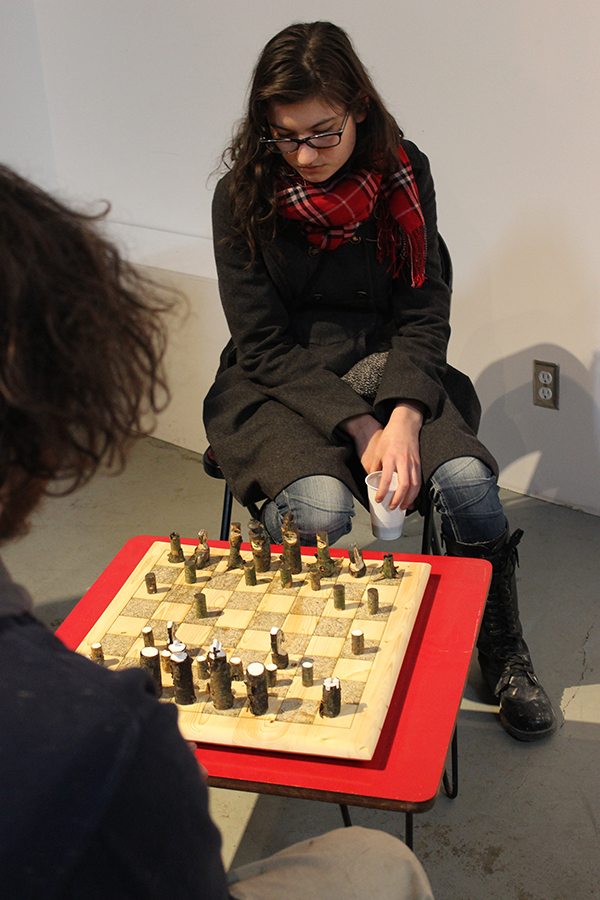 "Chess Set" by Andrew Krieger, with pieces whimsically wrought from branch segments.