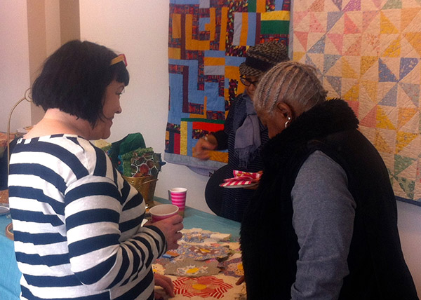Amy Corle (left) in conversation with one of the attendees.
