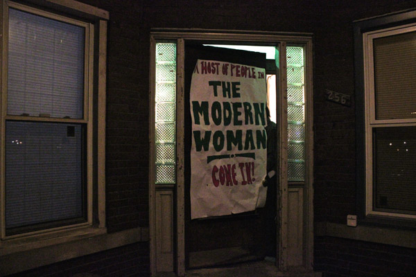 The performance is staged in a residential property on W. Grand Blvd.